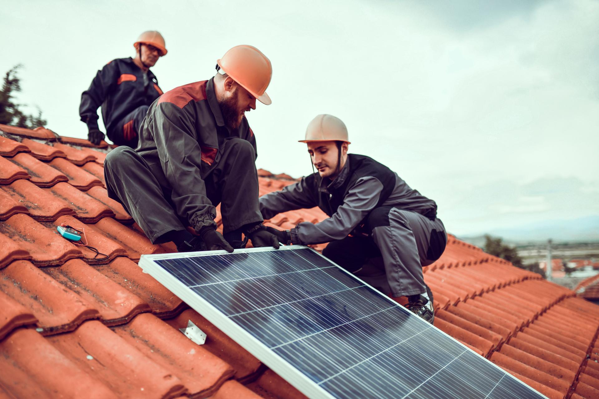 Workers Slowly Getting Down Solar Panel From House Roof To Take It For Repairs